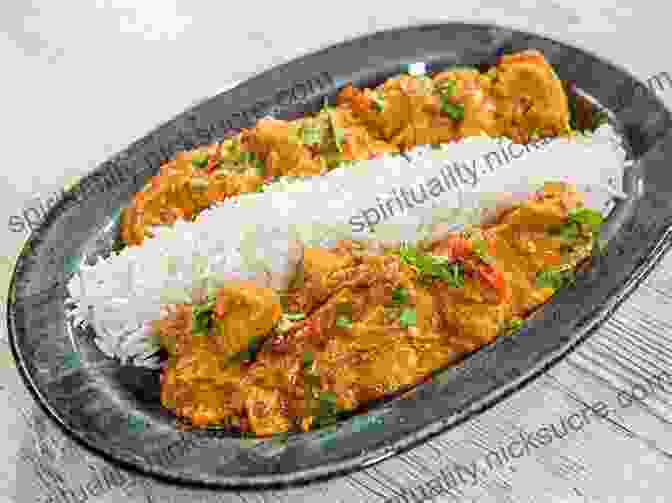 A Sizzling Plate Of Chicken Tikka Masala, Accompanied By Fluffy Basmati Rice. The Dutch Oven Cookbook: Recipes For The Best Pot In Your Kitchen