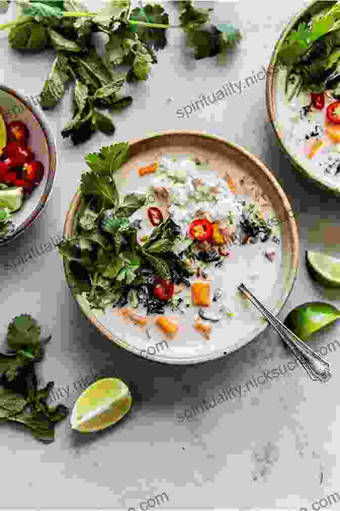 A Vibrant Bowl Of Spicy Thai Coconut Soup, Garnished With Fresh Cilantro And Sliced Chilies. The Dutch Oven Cookbook: Recipes For The Best Pot In Your Kitchen